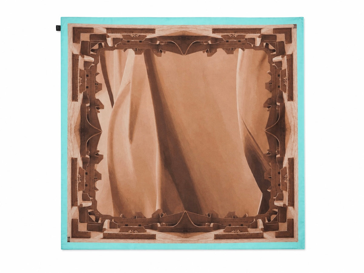 A square scarf featuring a symmetrical, geometric design with a brown and beige central motif framed by a turquoise border, shown flat against a white background.