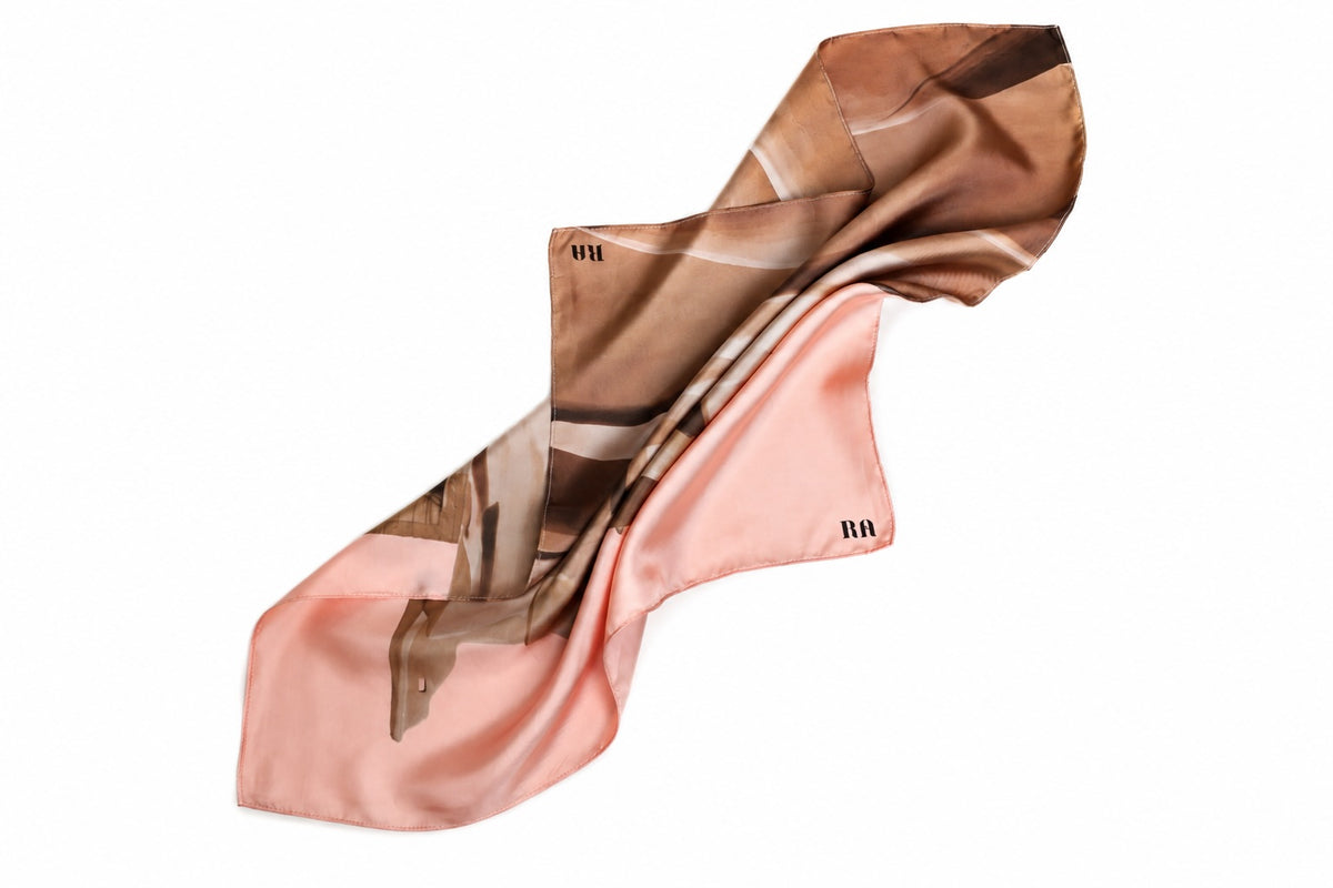 A lightweight silk scarf with a dual-tone abstract print, featuring a dusty pink lower half and a brown and beige upper half, displayed on a clean white background.